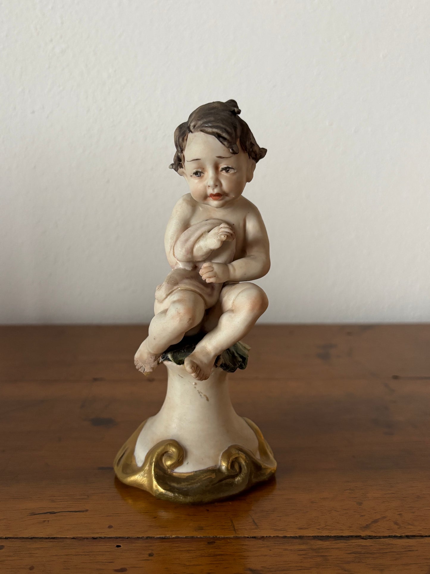 Cherub figurine with blanket