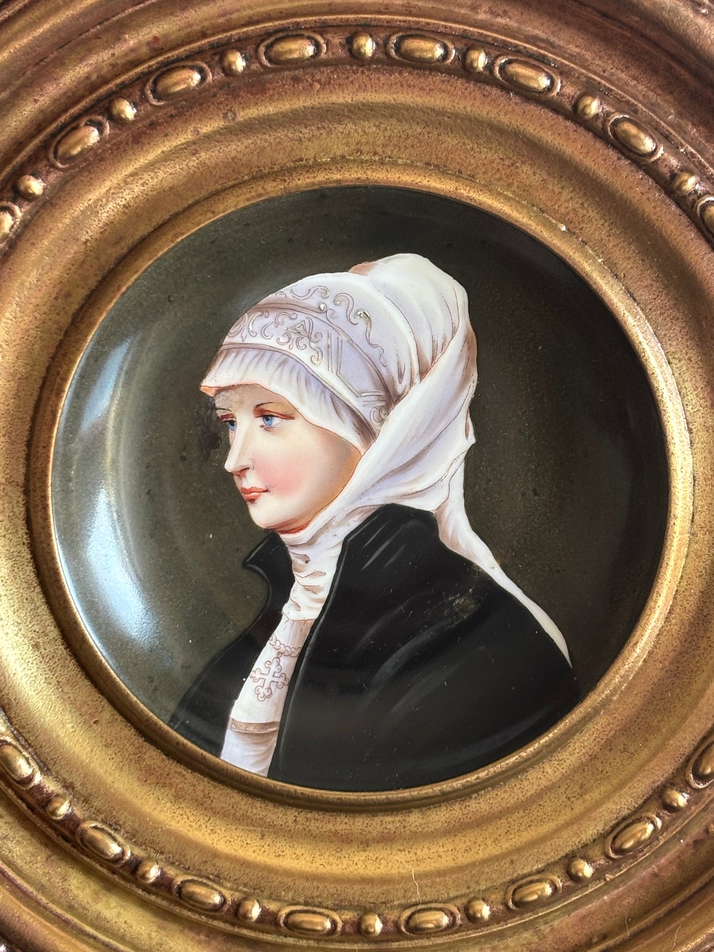 Piatto in ceramica con miniatura di nobildonna e cornice in metallo lavorato a sbalzo