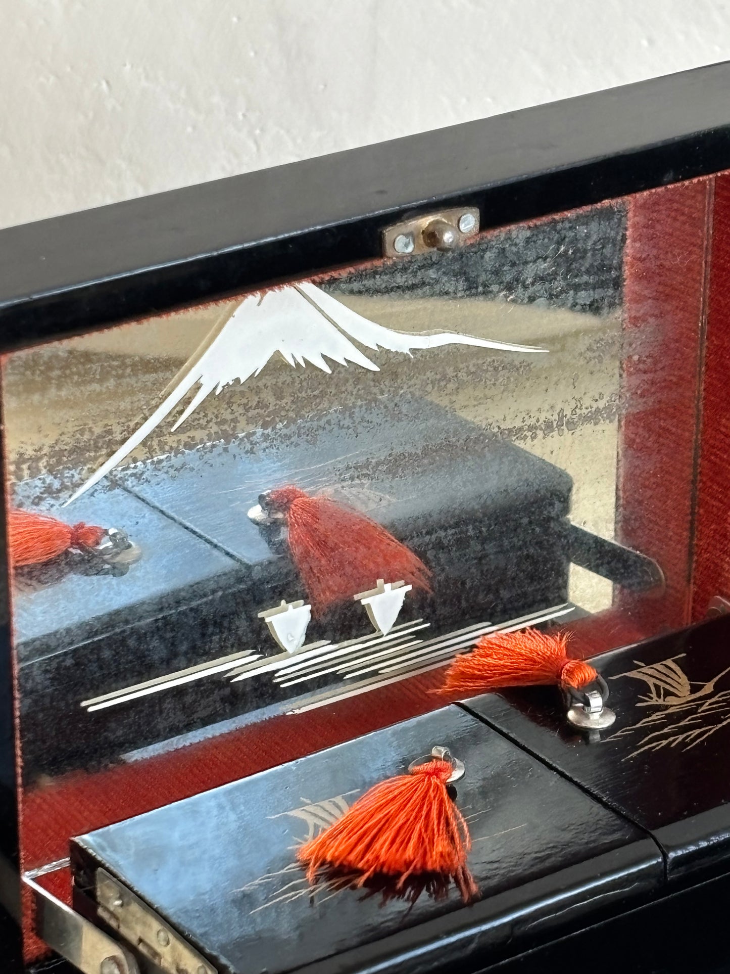 Small vintage music box with key, lacquered case and Mount Fuji on the mirror