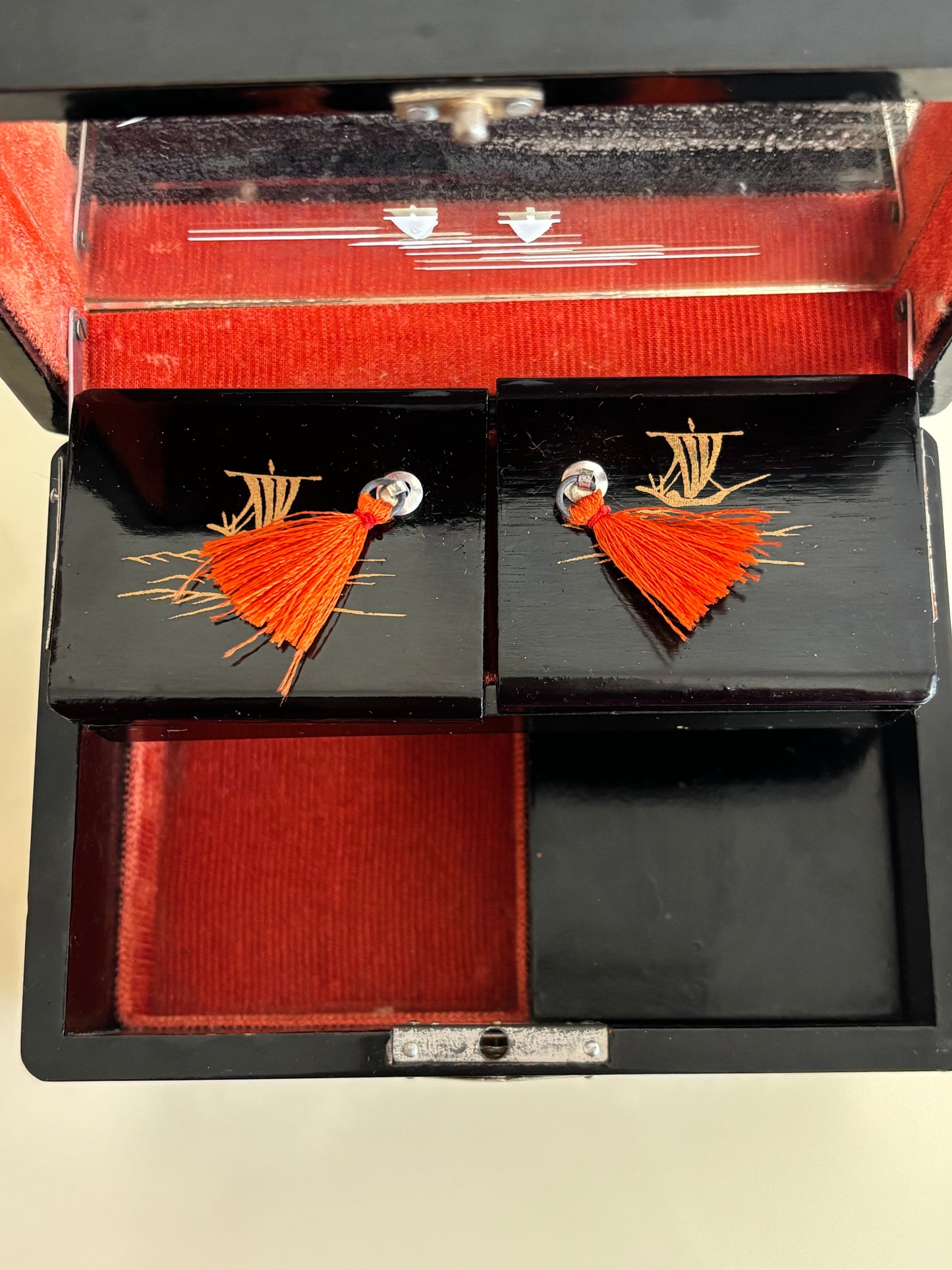 Small vintage music box with key, lacquered case and Mount Fuji on the mirror