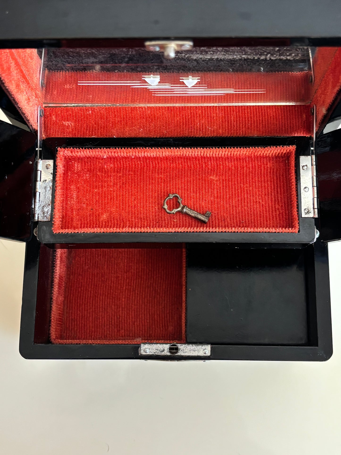 Small vintage music box with key, lacquered case and Mount Fuji on the mirror