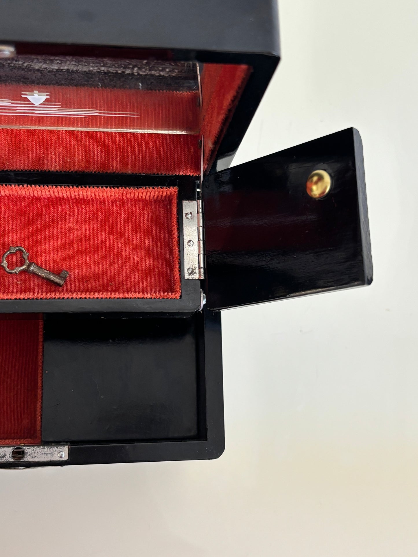 Small vintage music box with key, lacquered case and Mount Fuji on the mirror