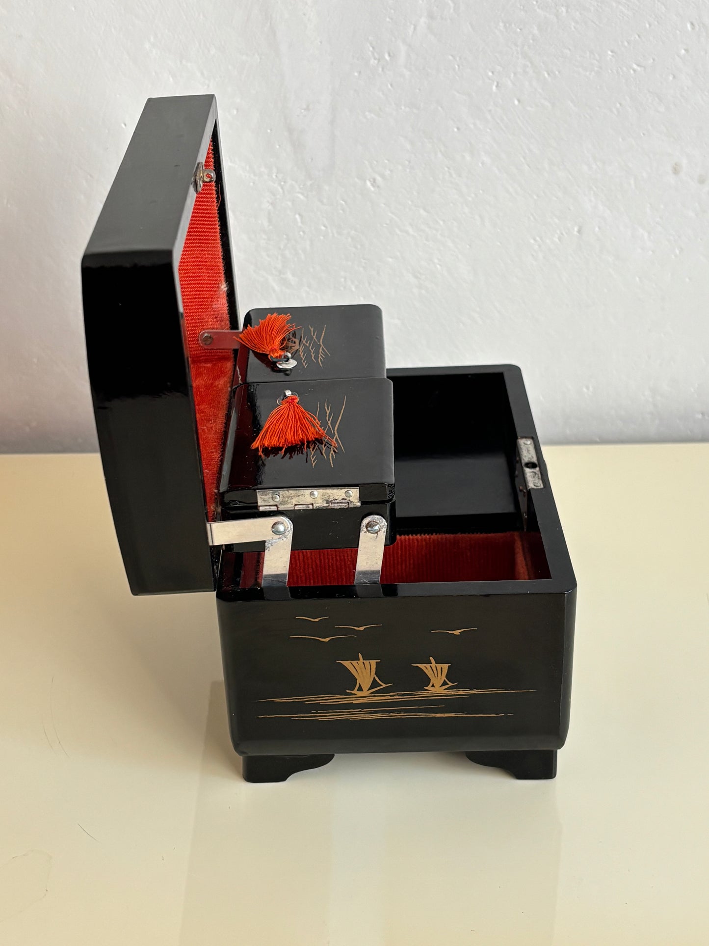 Small vintage music box with key, lacquered case and Mount Fuji on the mirror