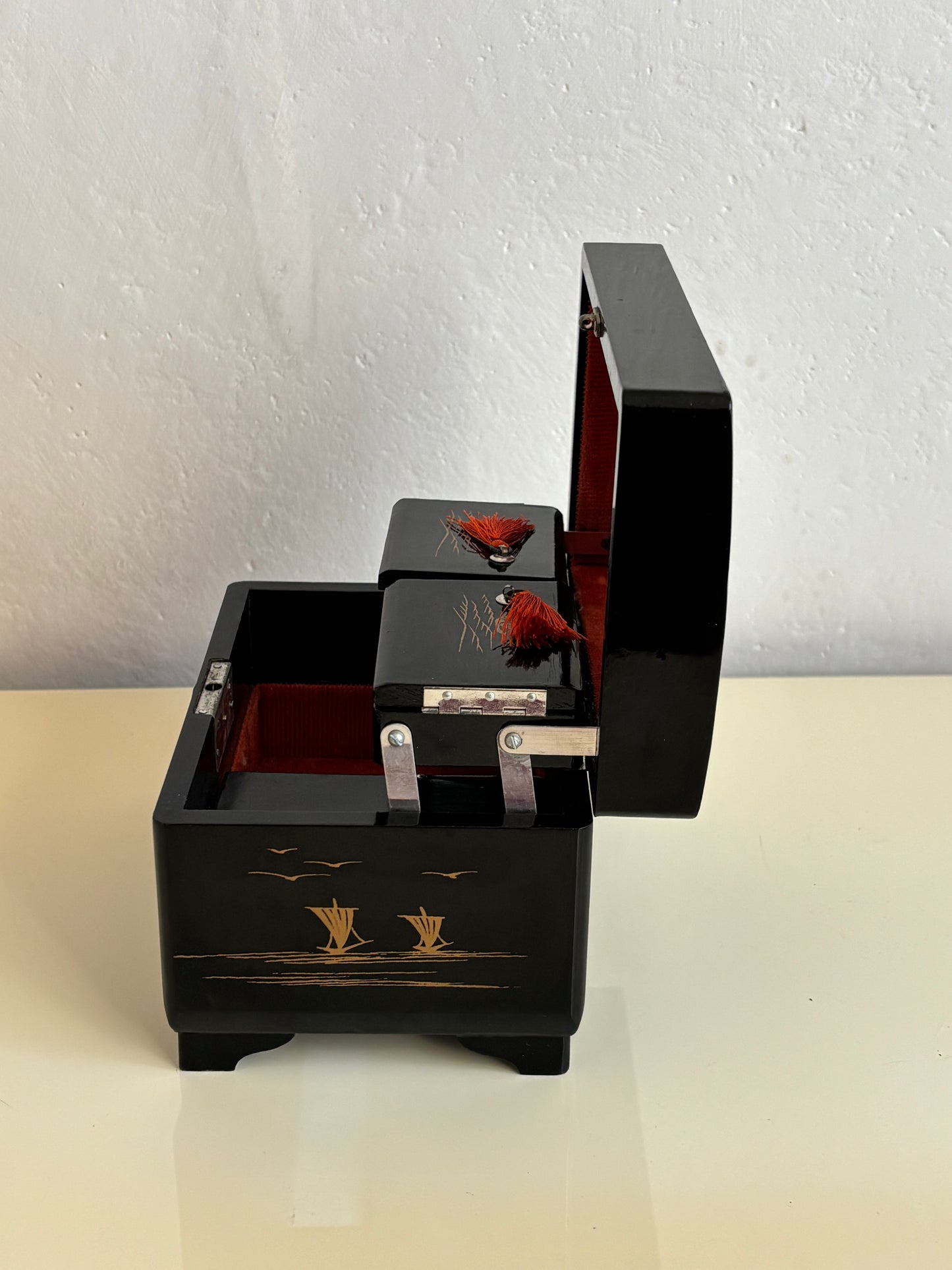 Small vintage music box with key, lacquered case and Mount Fuji on the mirror