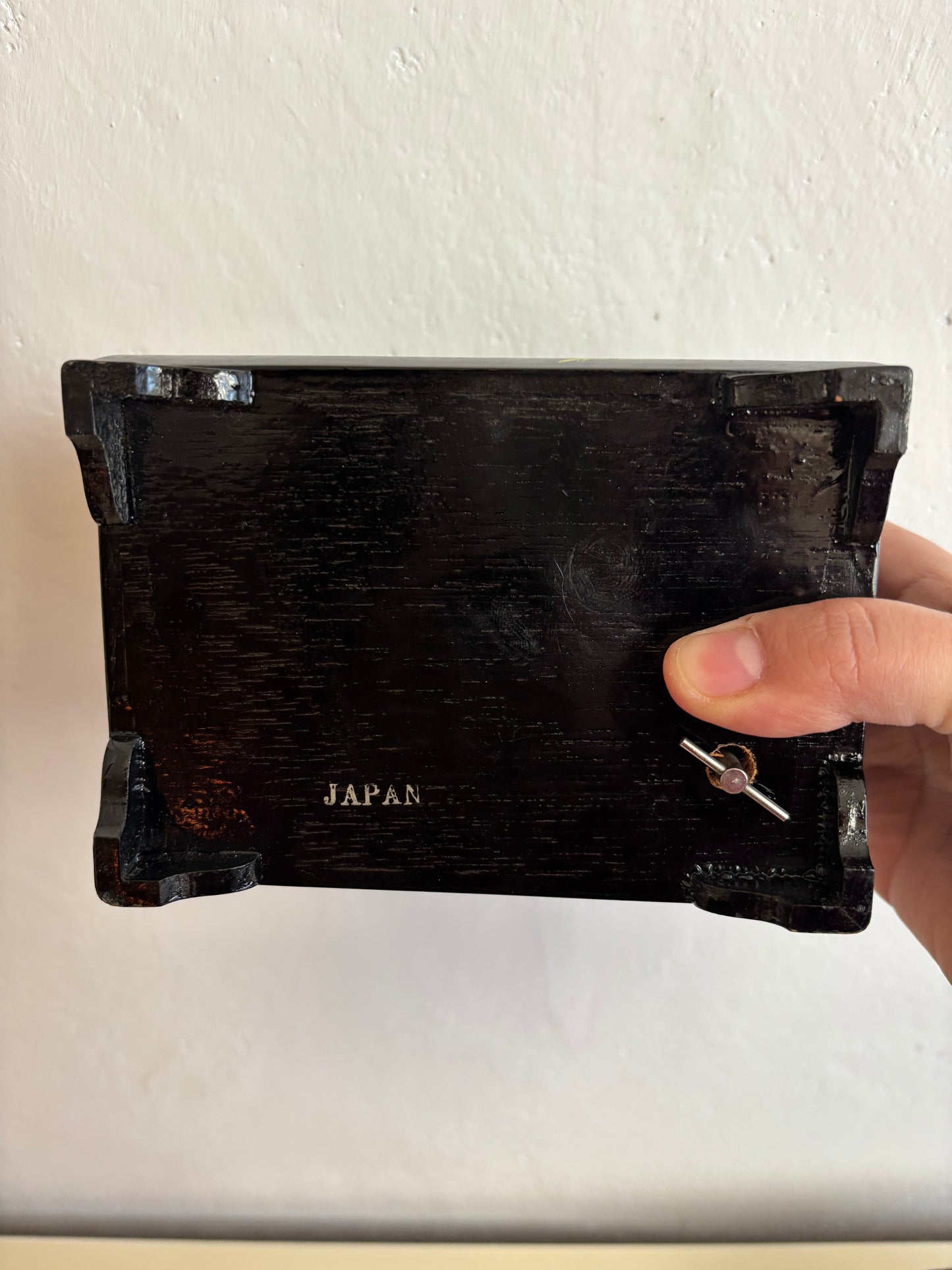 Small vintage music box with key, lacquered case and Mount Fuji on the mirror