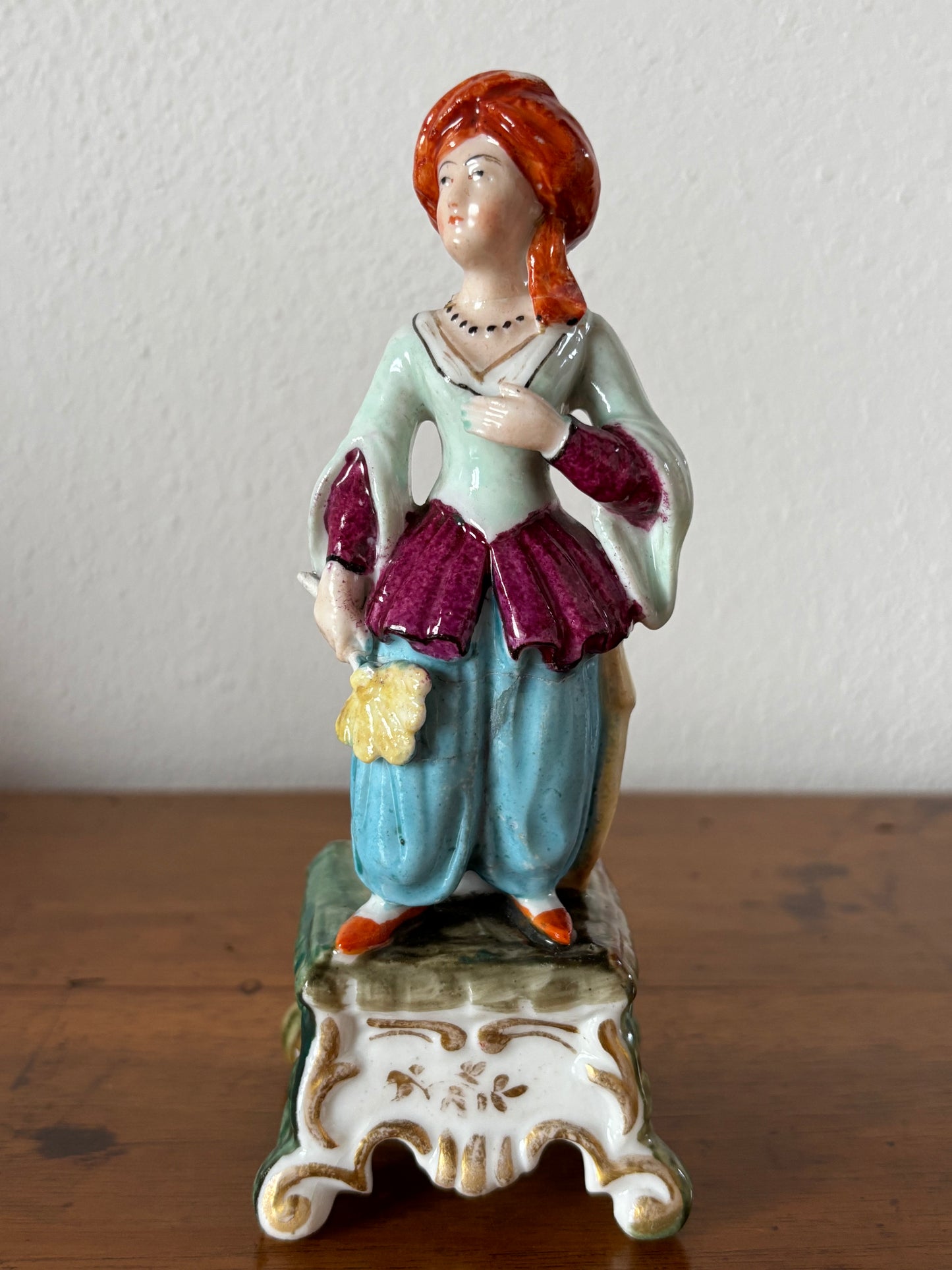 Antique inkstand with a figurine of a woman in 18th-century attire