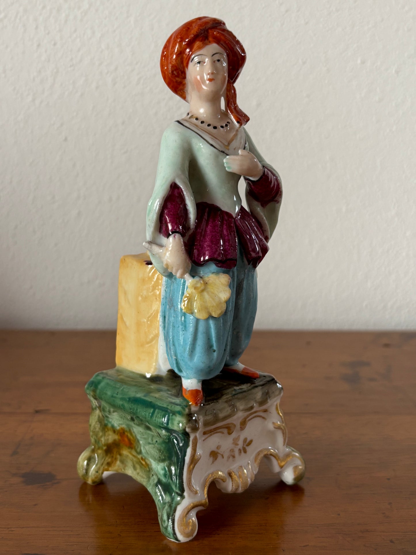 Antique inkstand with a figurine of a woman in 18th-century attire