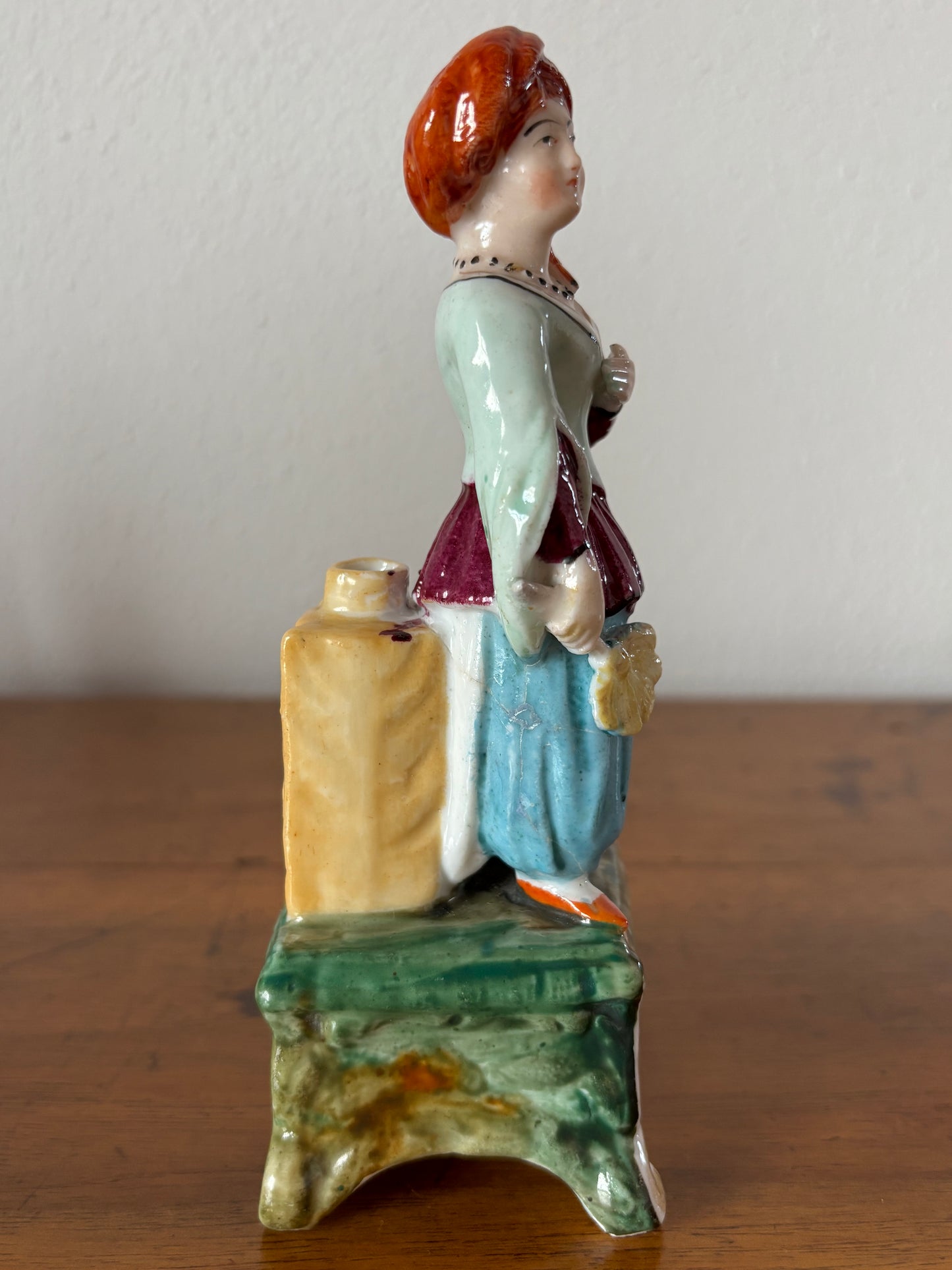 Antique inkstand with a figurine of a woman in 18th-century attire