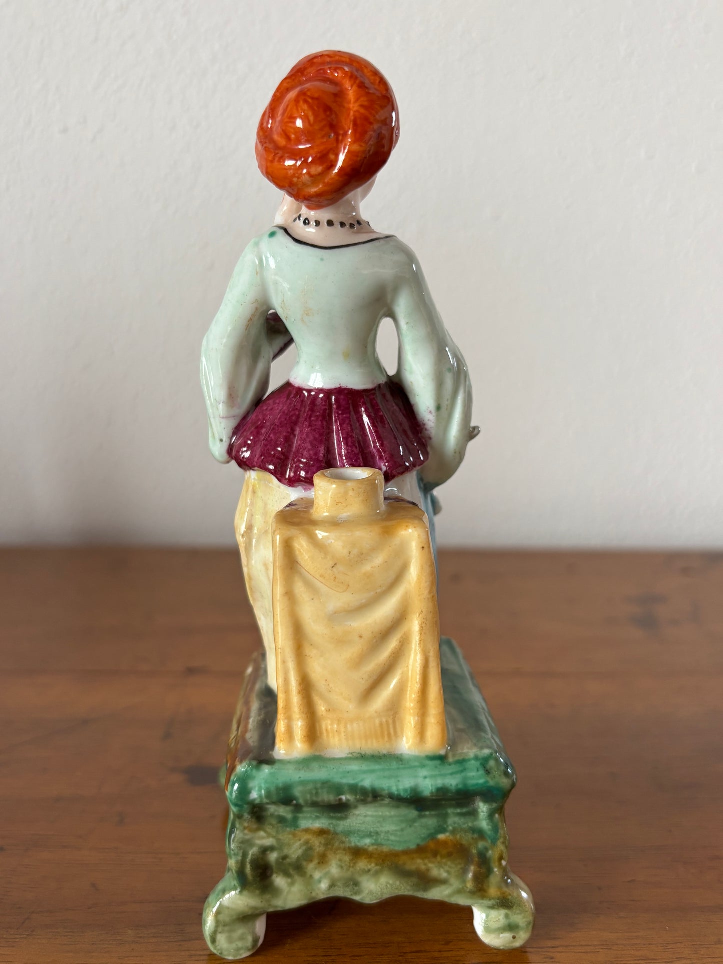 Antique inkstand with a figurine of a woman in 18th-century attire