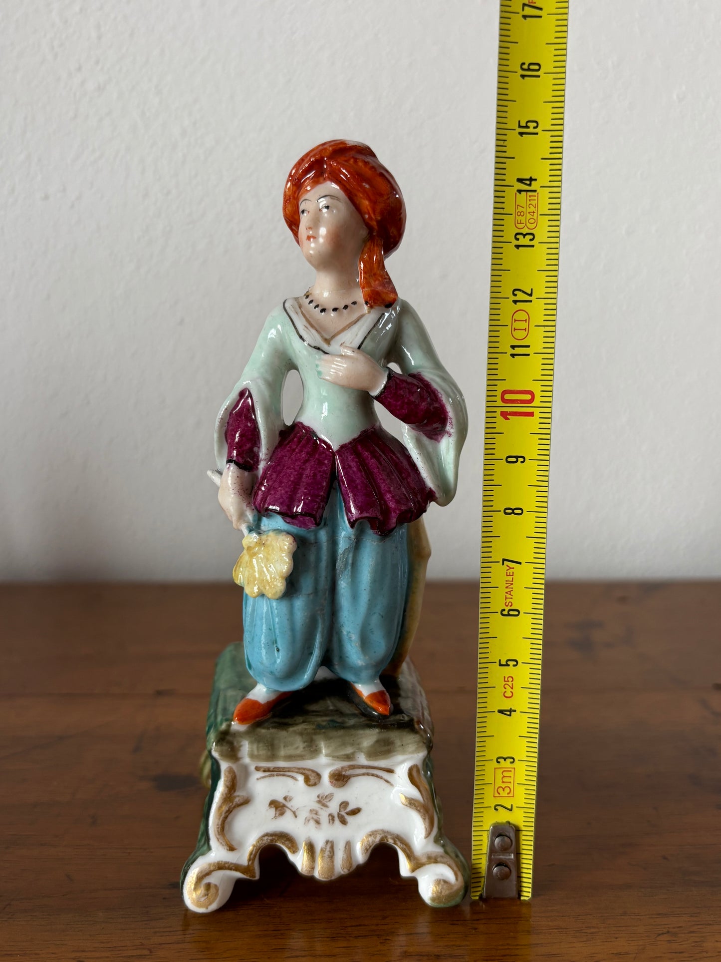 Antique inkstand with a figurine of a woman in 18th-century attire